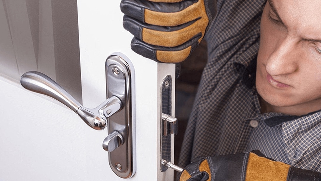 Locksmith installing a residential door lock in Los Angeles